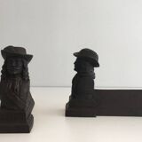 Pair of cast iron andirons in the likeness of a musketeer