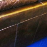 Patinated brown stitched leather 2 seater sofa with brass studs