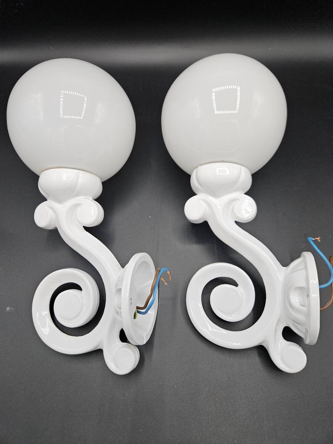 Pair of white enameled cast iron wall sconces, mid-20th century