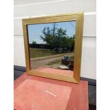 Wooden mirror and gold trim