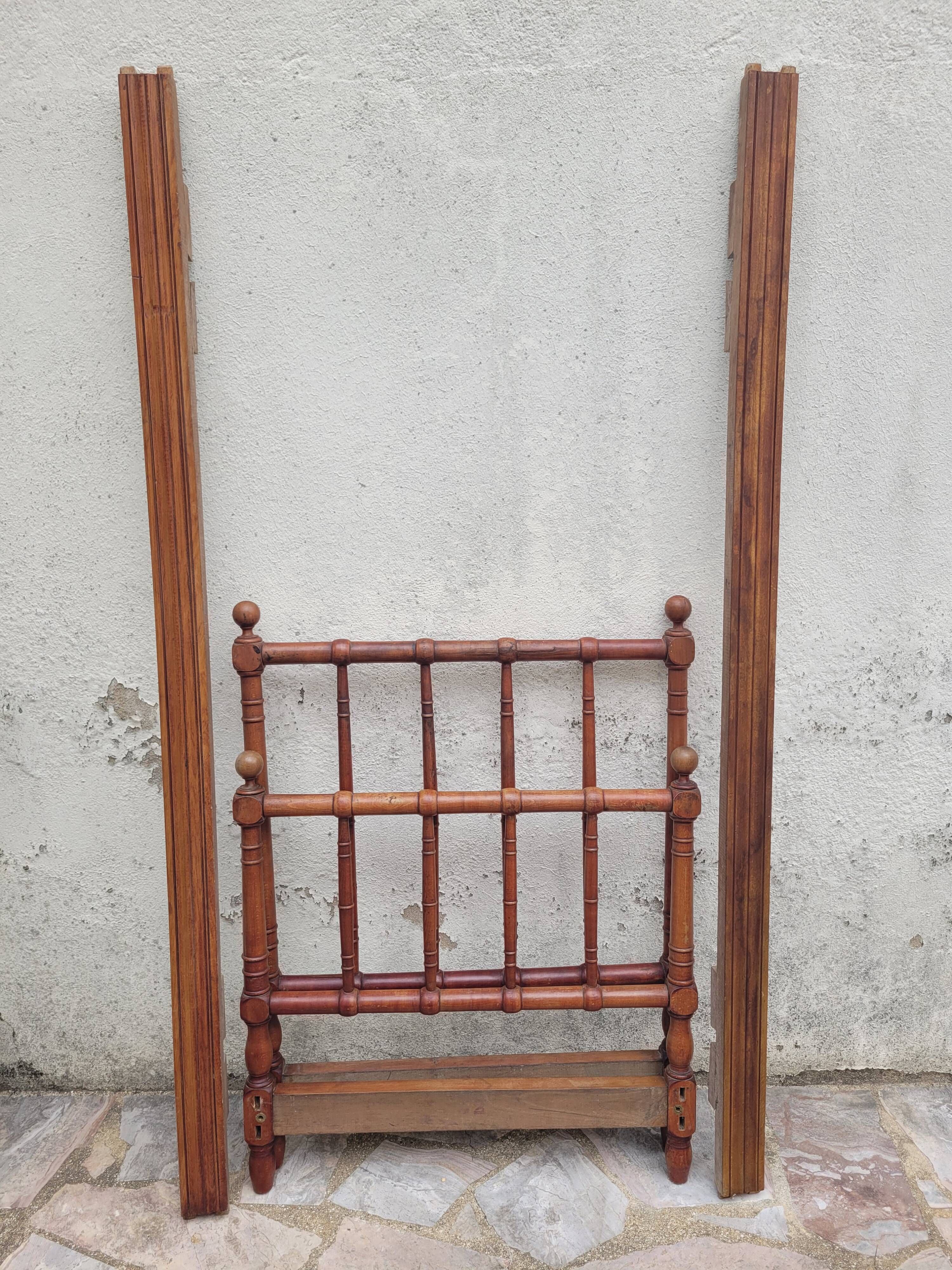 Child's bed or vintage rest bed made of solid cherry wood in a bamboo style.