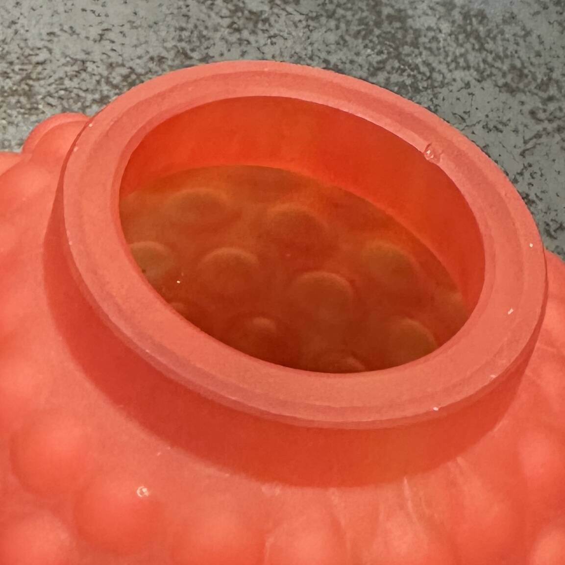 Small Art Deco ball vase in red-orange tinted glass