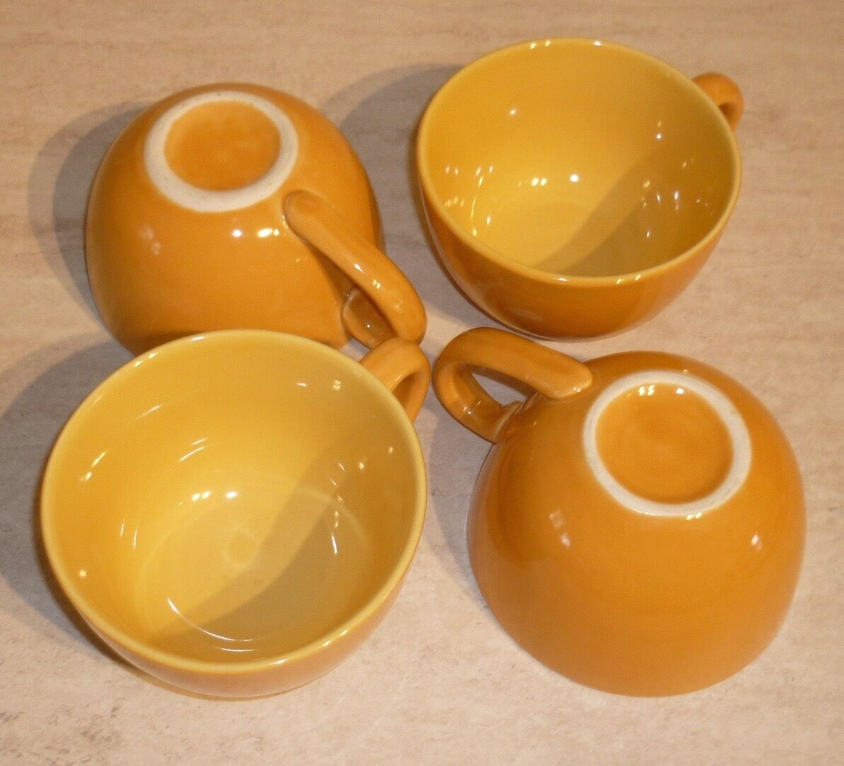 4 yellow and orange ceramic cups