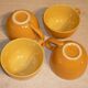 4 yellow and orange ceramic cups