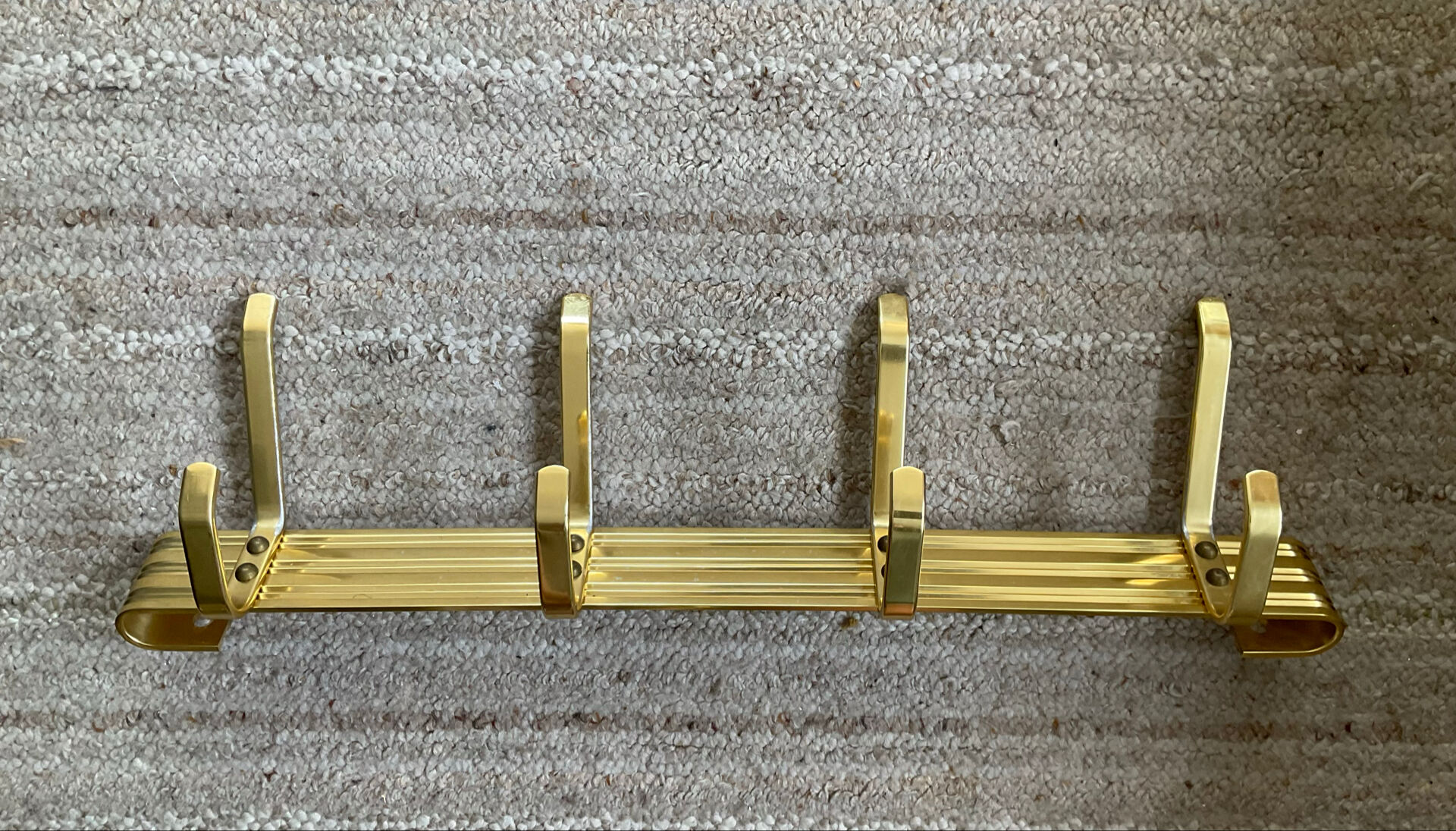 Golden wall-mounted coat rack from the 70s.