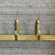 Golden wall-mounted coat rack from the 70s.