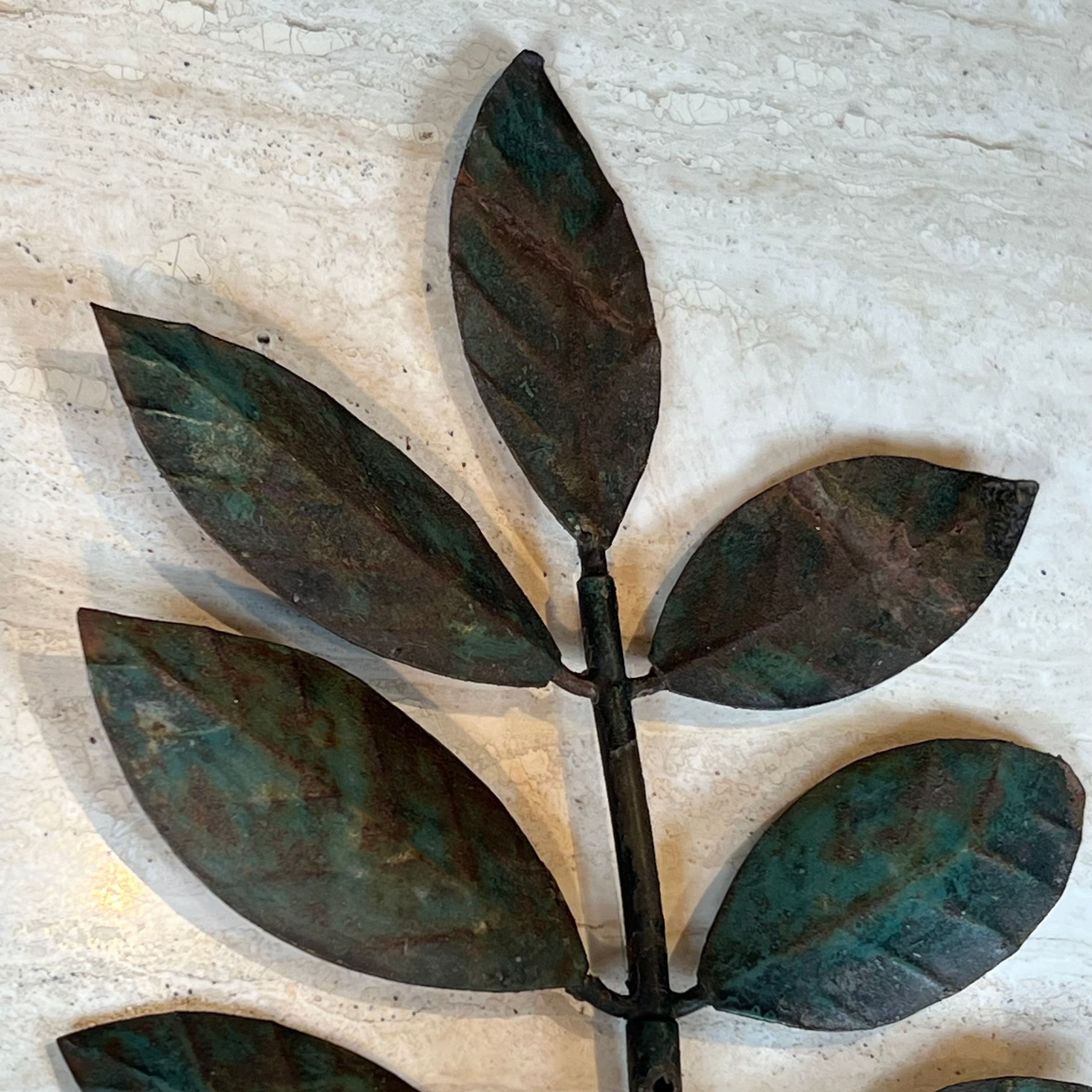 Pair of decorative wall sconces with sunflowers and patinated metal foliage.
