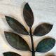 Pair of decorative wall sconces with sunflowers and patinated metal foliage.