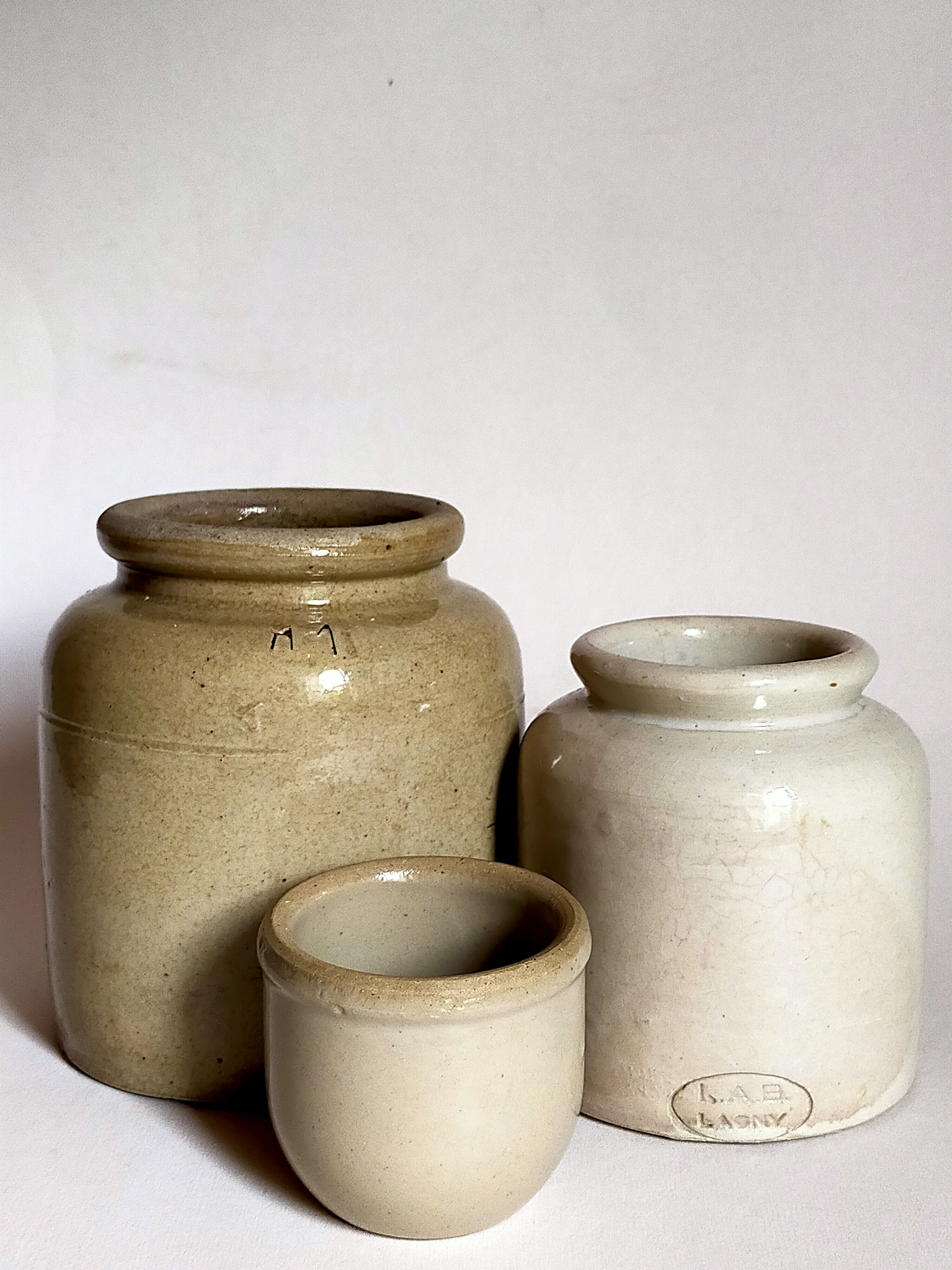 Set of three pots with old condiments in glazed earth
