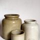 Set of three pots with old condiments in glazed earth