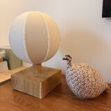 Handmade wooden ball lamp on a stand