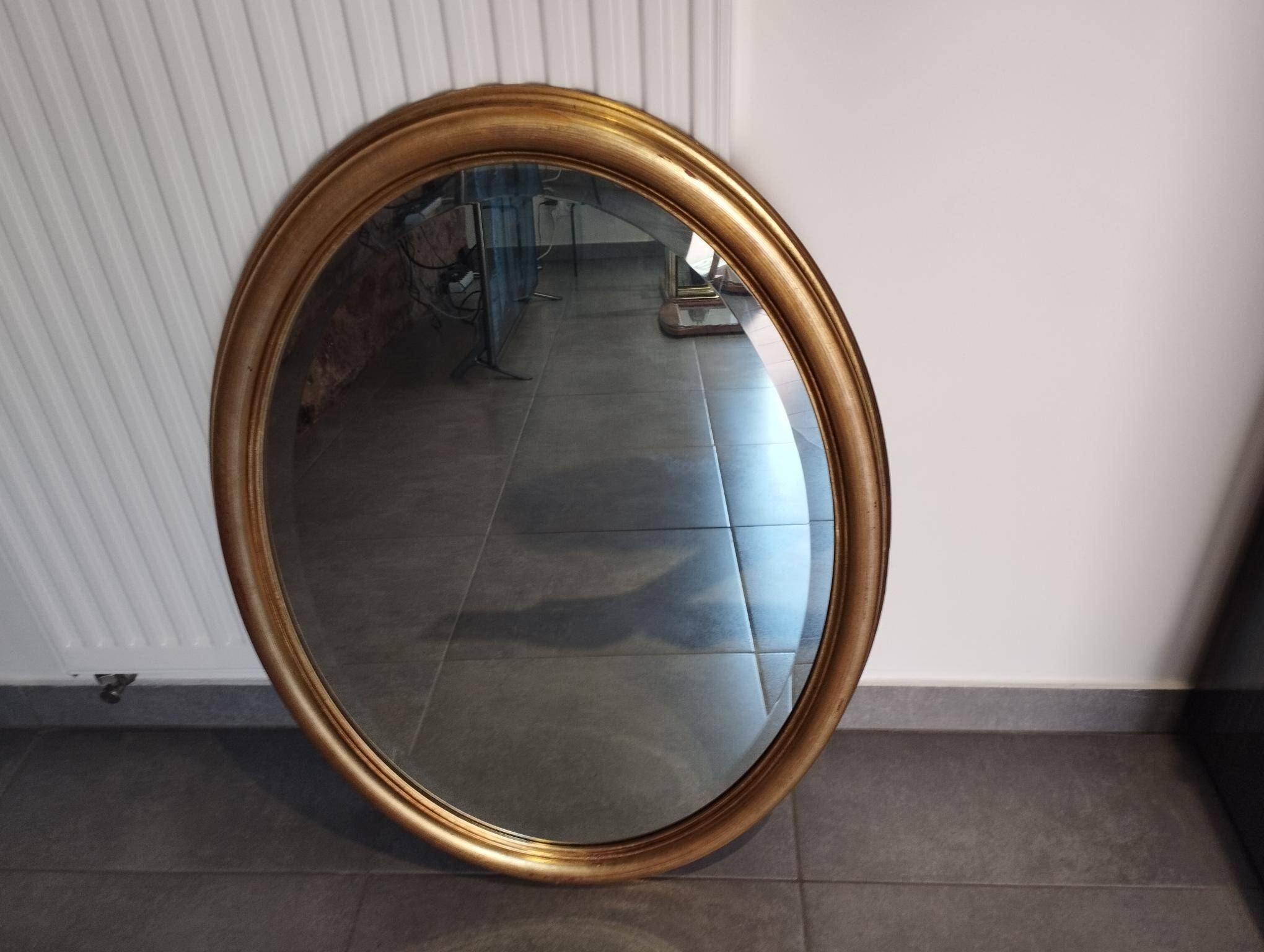 Grand et élégant miroir doré ovale avec sa glace biseauté