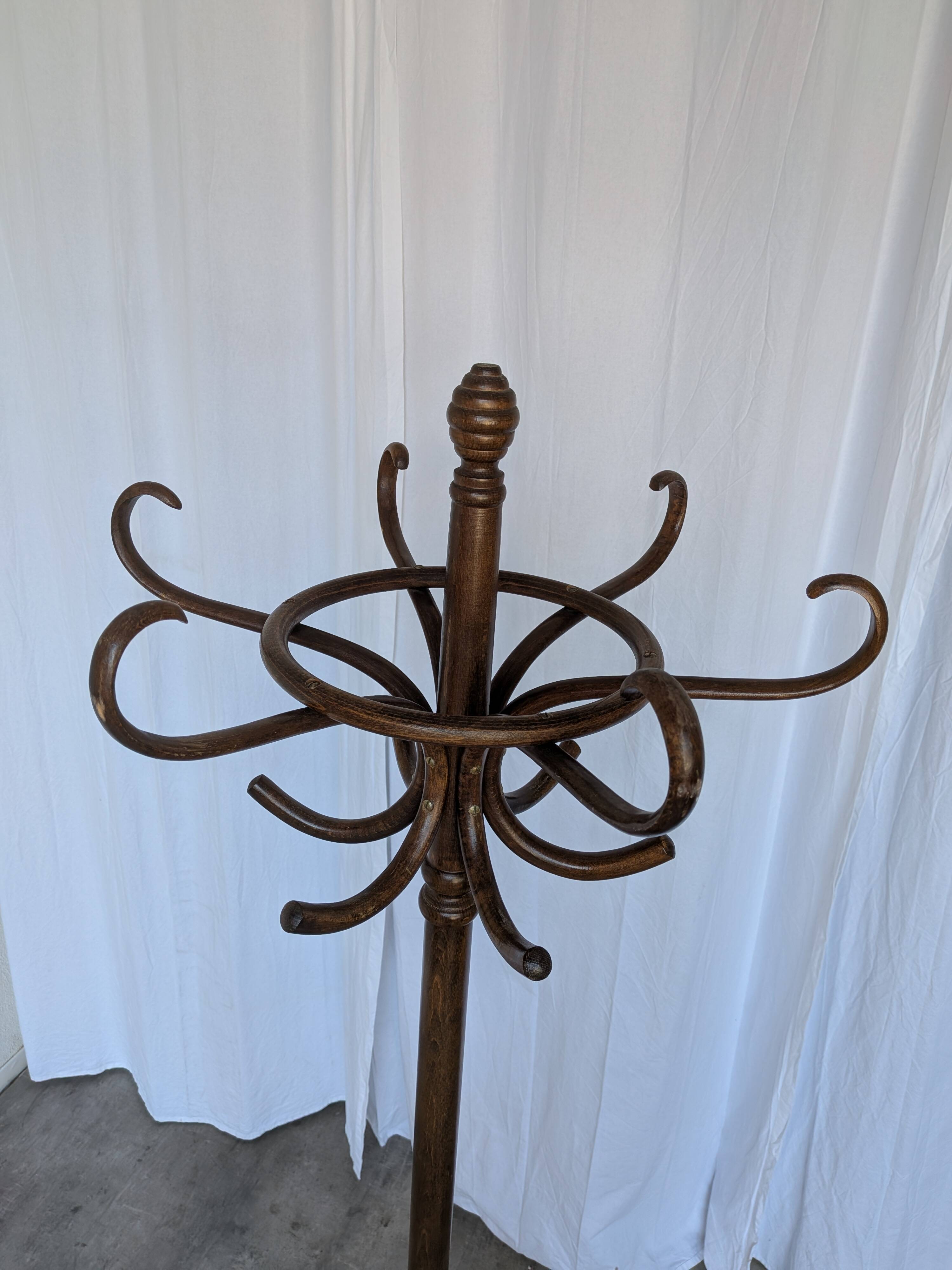 Vintage bentwood coat rack in Thonet style / Dark wood coat rack with shadow.