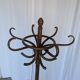 Vintage bentwood coat rack in Thonet style / Dark wood coat rack with shadow.