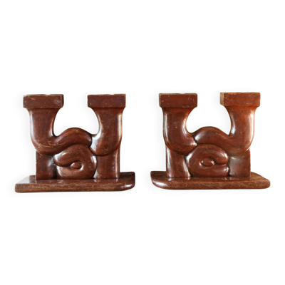 Paire de bougeoirs art déco en bois sculpté, signés Delaporte