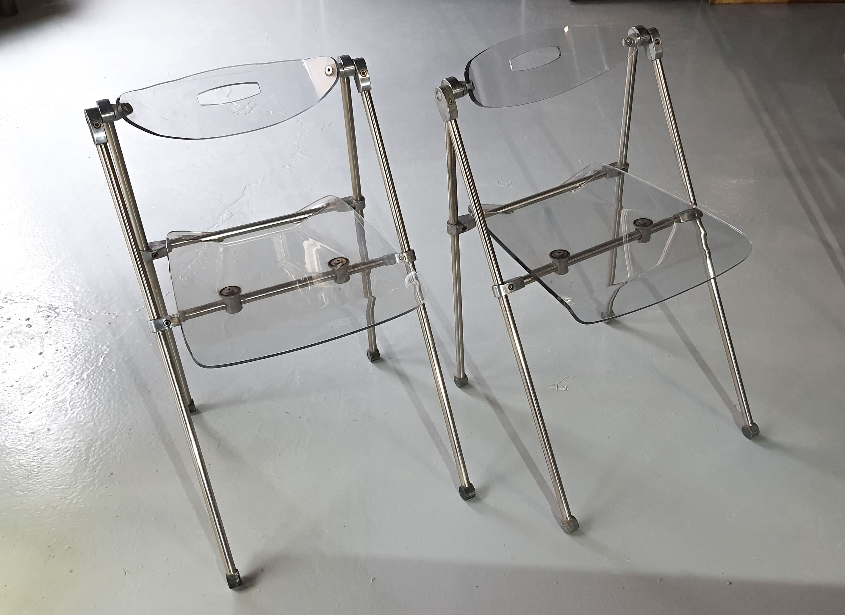 Pair of modern folding chairs in plexiglass