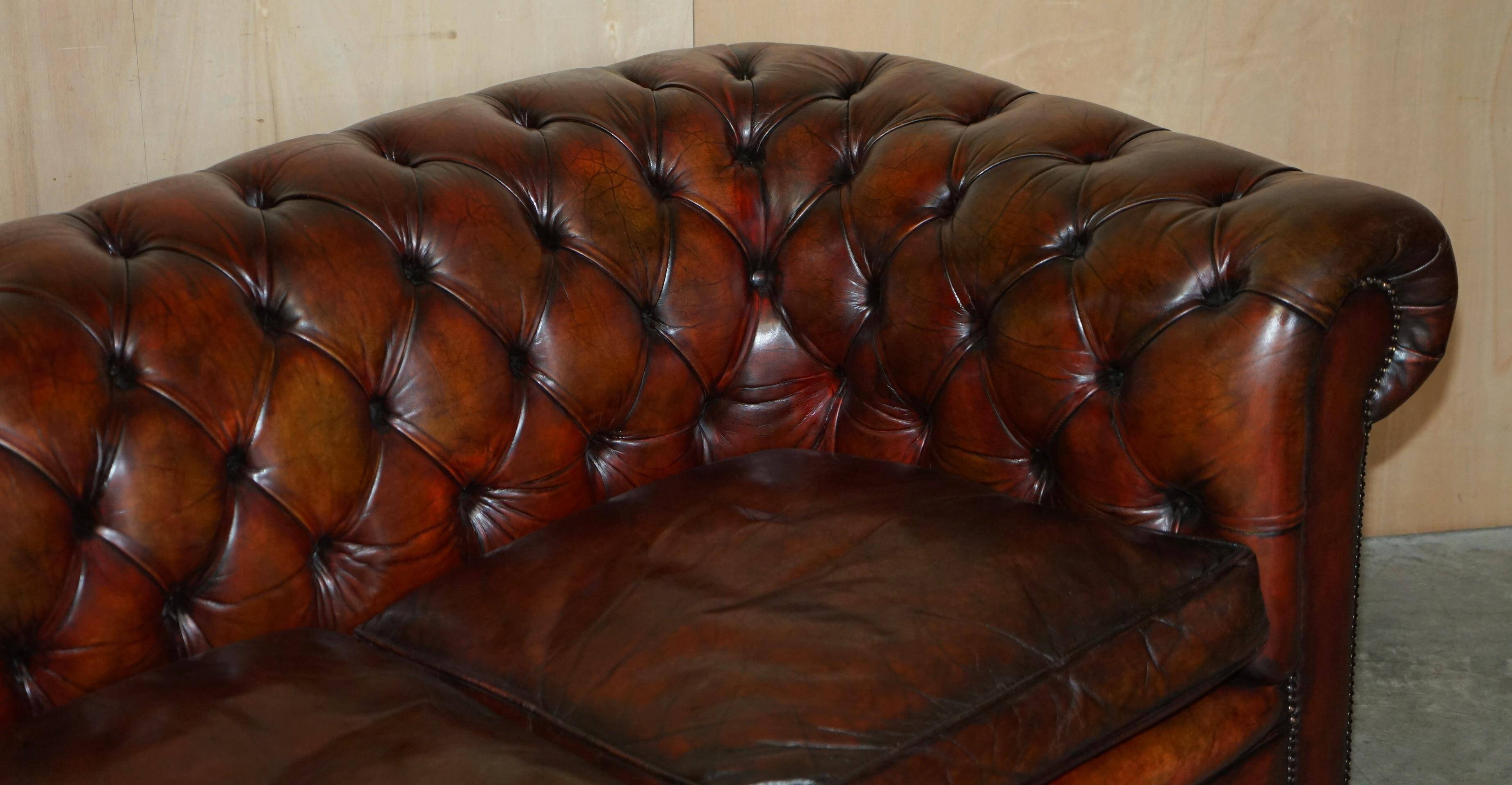 Pair of restored antique Chesterfield sofas in Boudreaux leather.