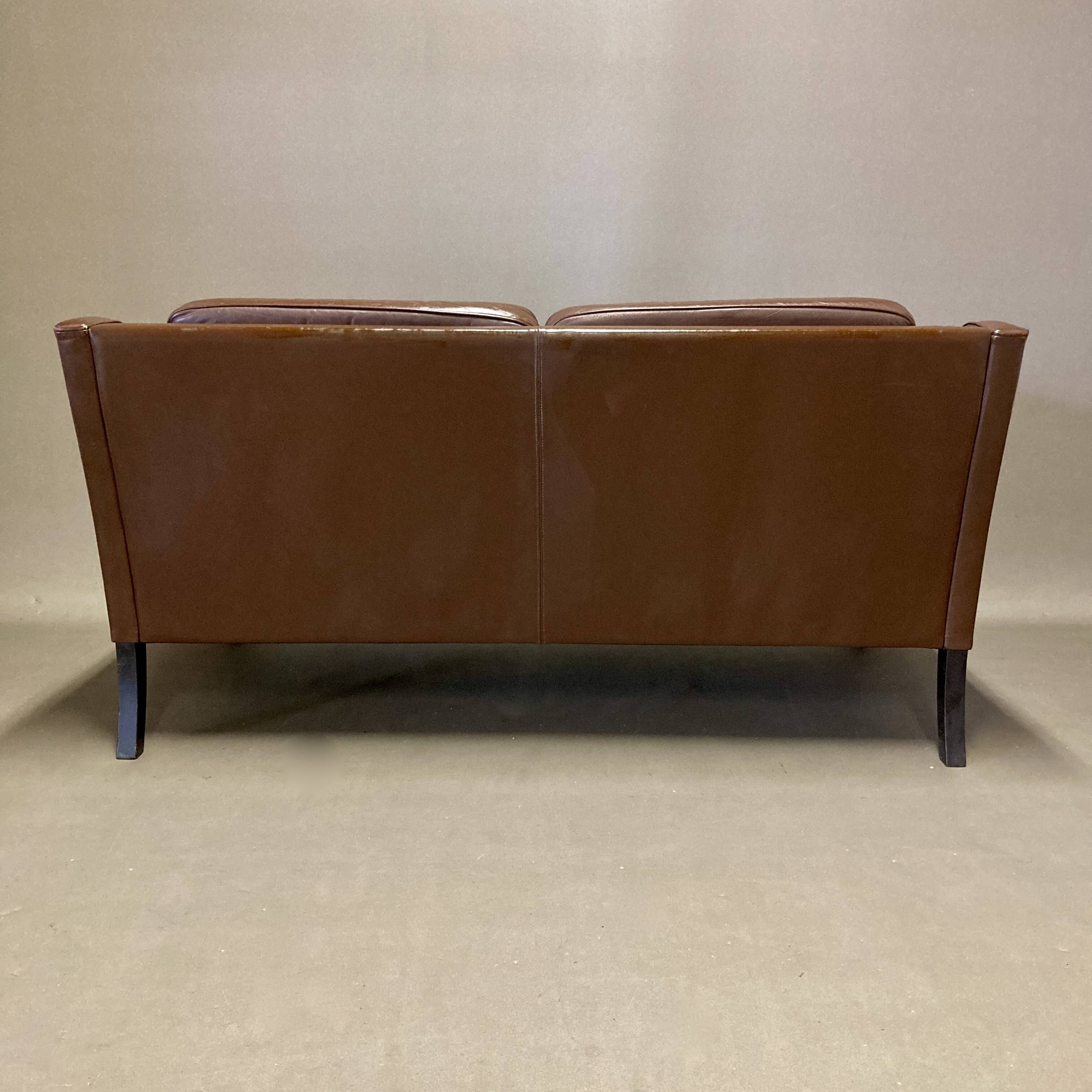 Scandinavian design 2-seater leather sofa.