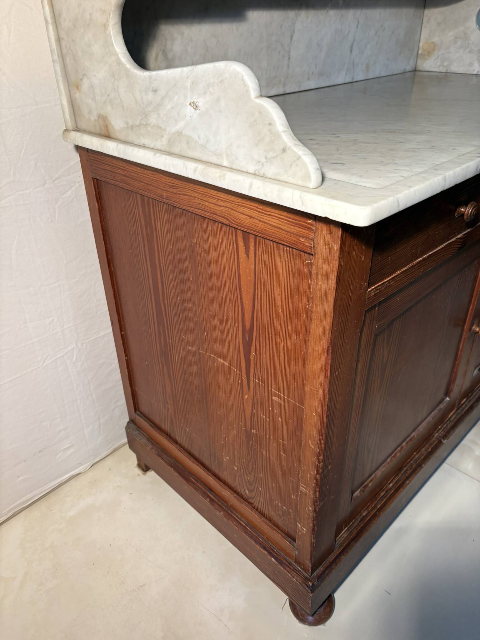 Antique wood and marble kitchen sideboard with carved backsplash