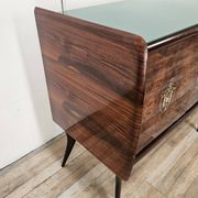Mid-century mahogany buffet with teal glass and compartments with a drawer.