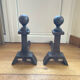 Pair of massive antique-style fire dogs in solid iron from the 20th century.