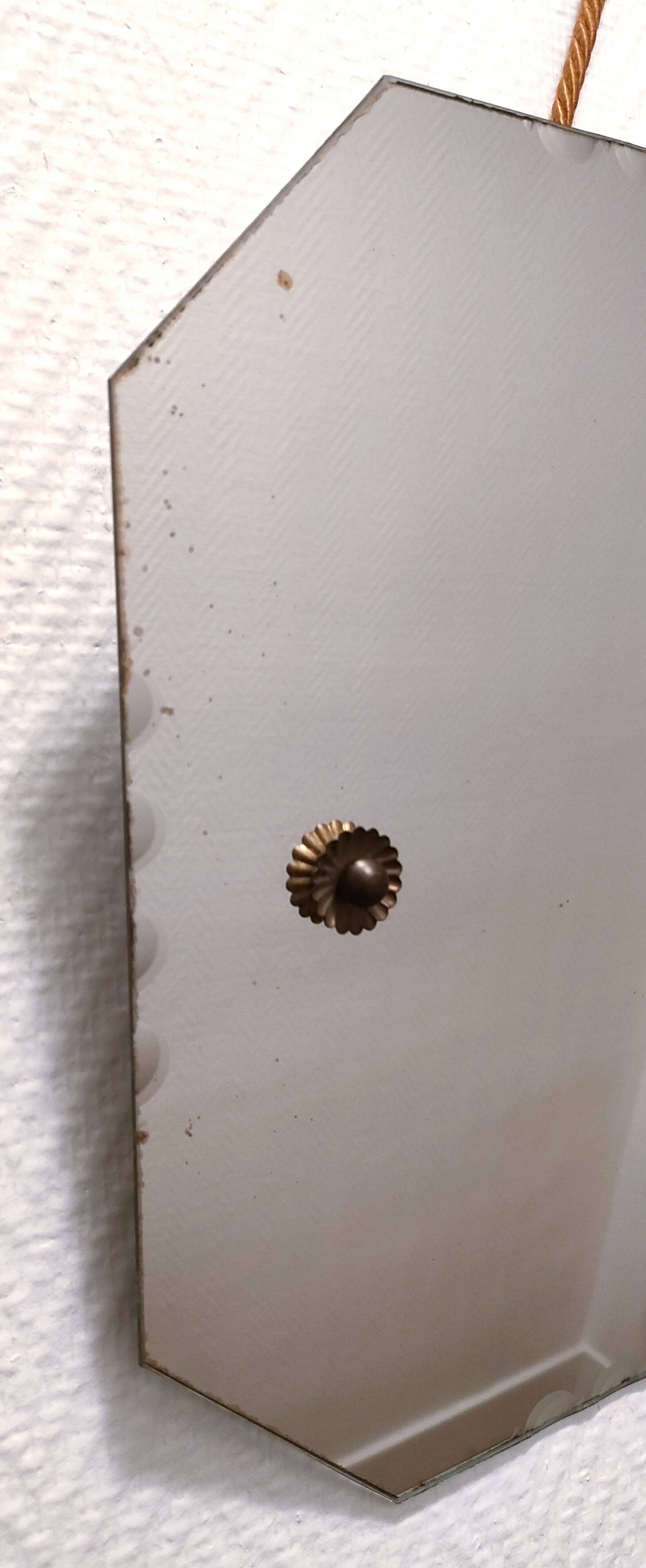 Octagonal mirror with brass hubcaps from the 60s