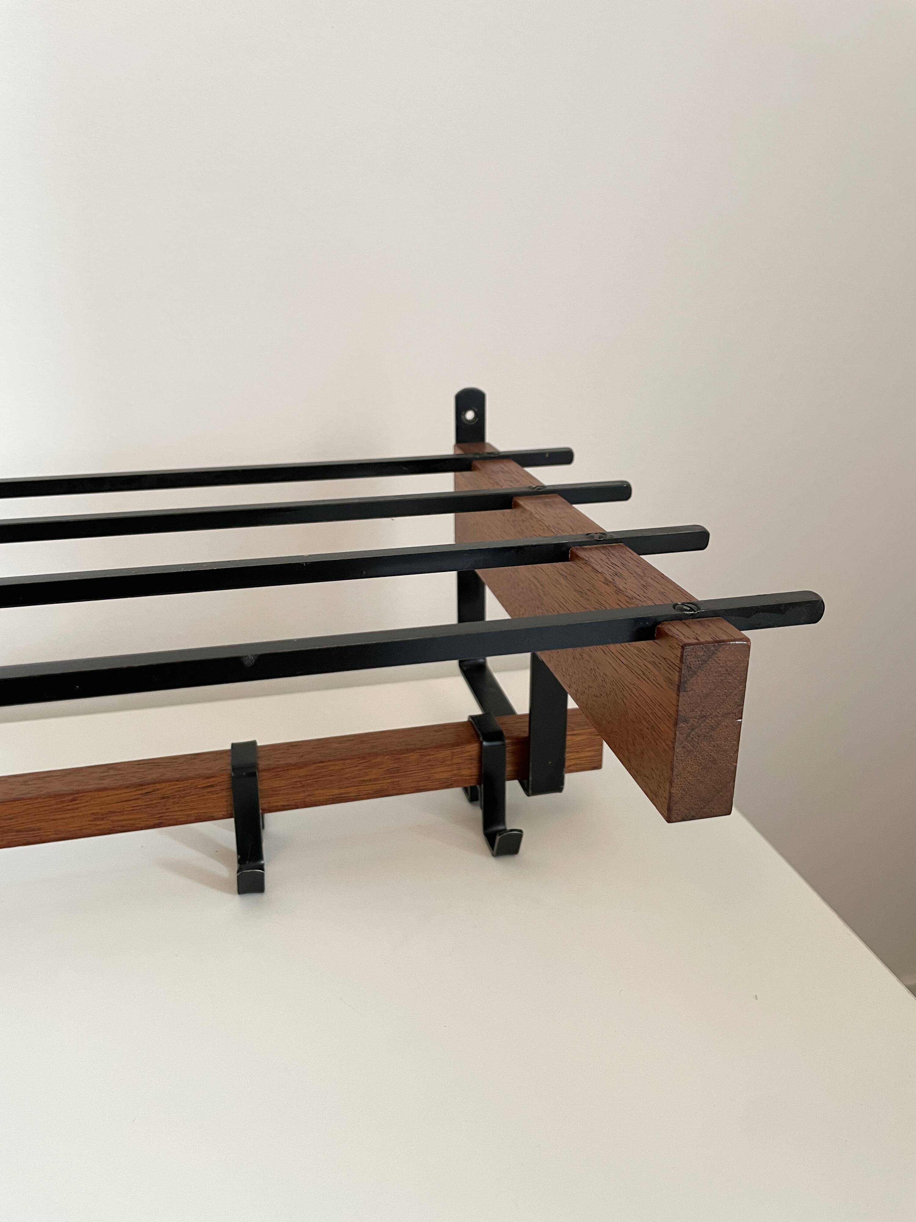 Vintage Scandinavian wall coat rack in wood and metal.