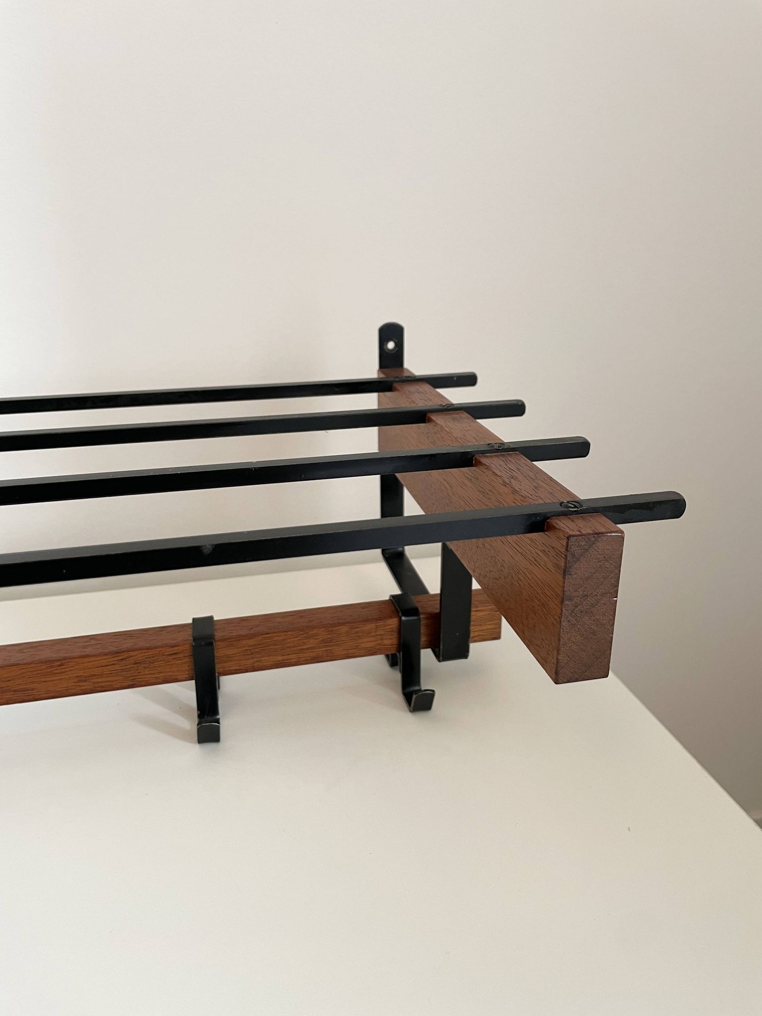 Vintage Scandinavian wall coat rack in wood and metal.