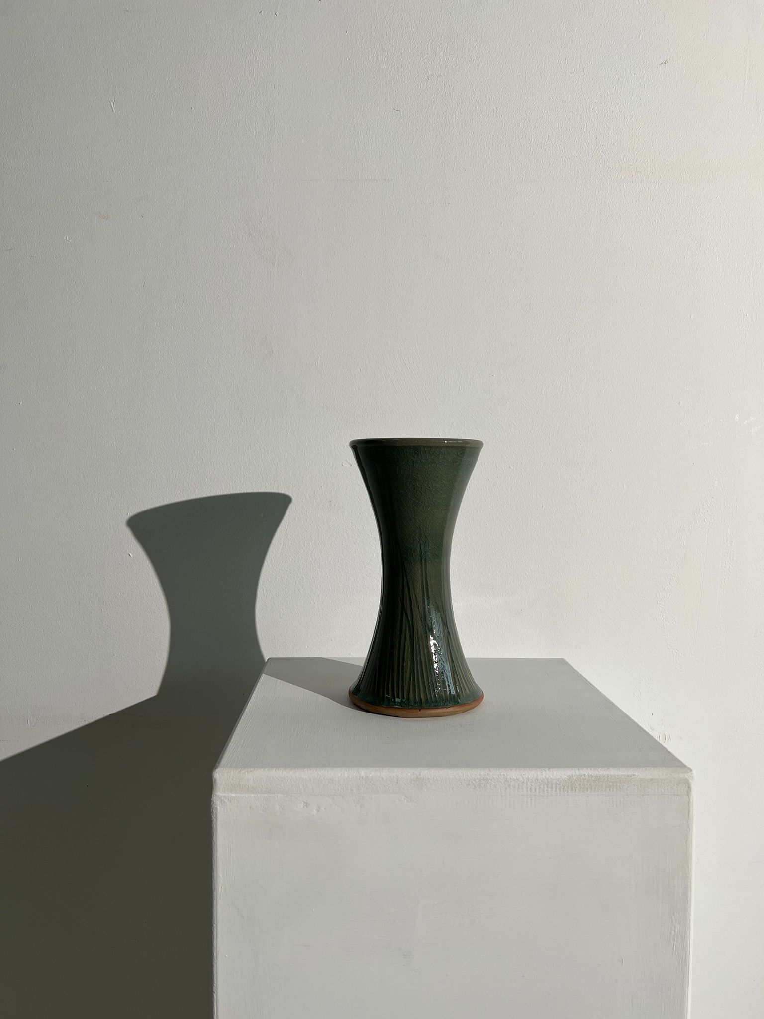 Dark green handcrafted vase with glazed ceramic grass blades