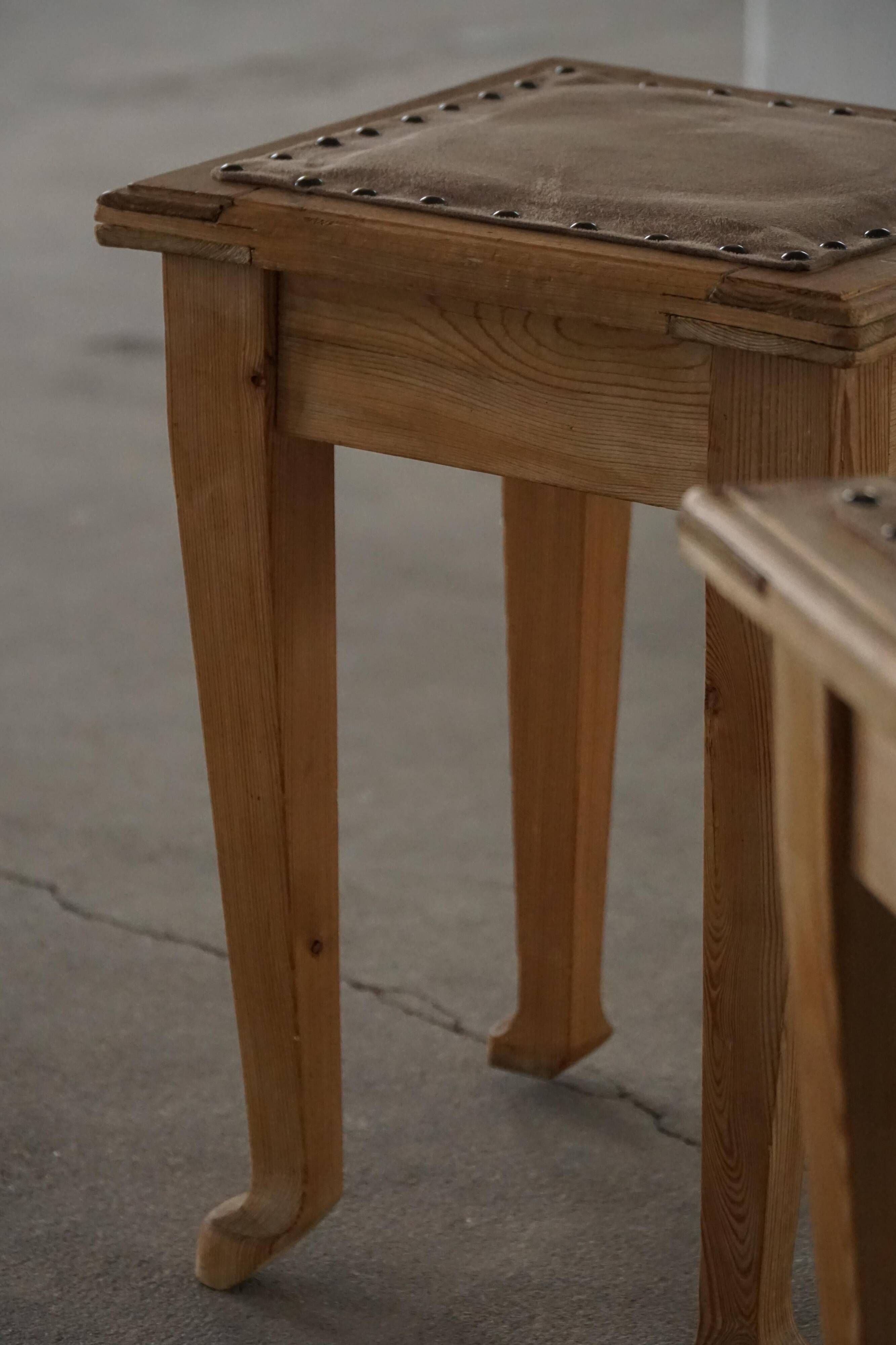 A pair of antique Danish pine stools from the late 19th century.