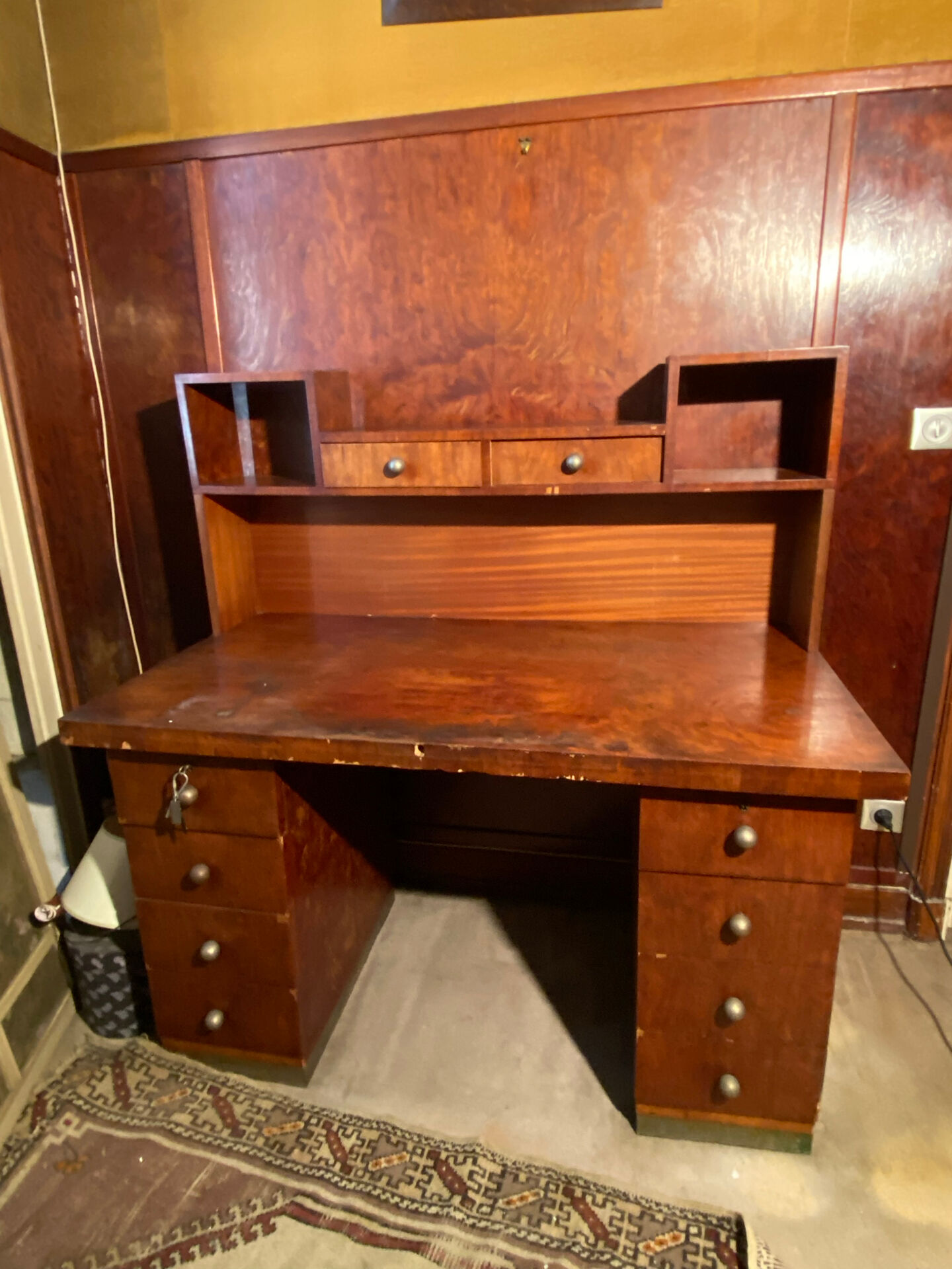 Vintage desk with drawers and a hutch with numerous drawers.