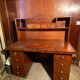 Vintage desk with drawers and a hutch with numerous drawers.