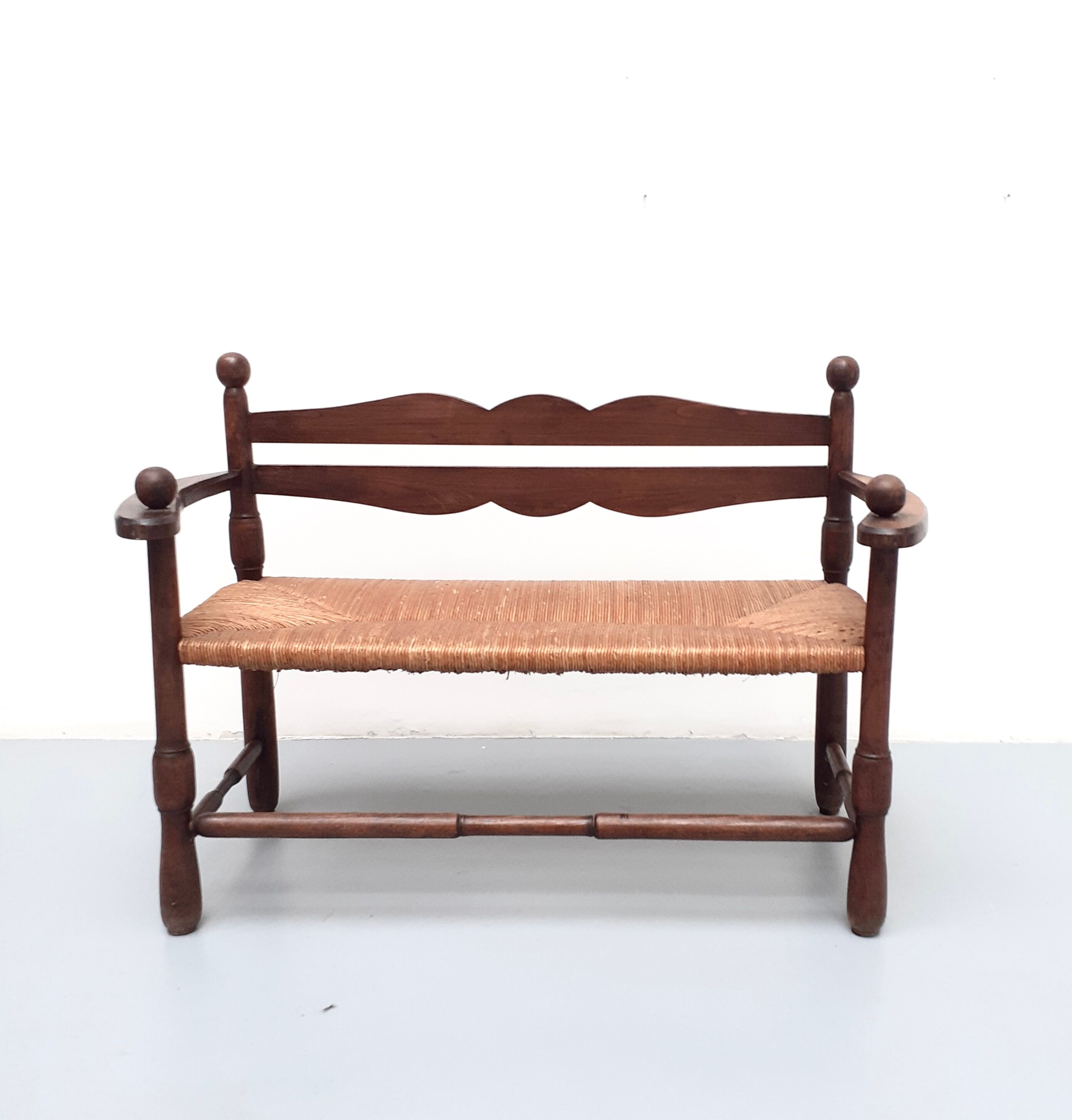 Vintage bench with wooden backrest and structure and mulched seat