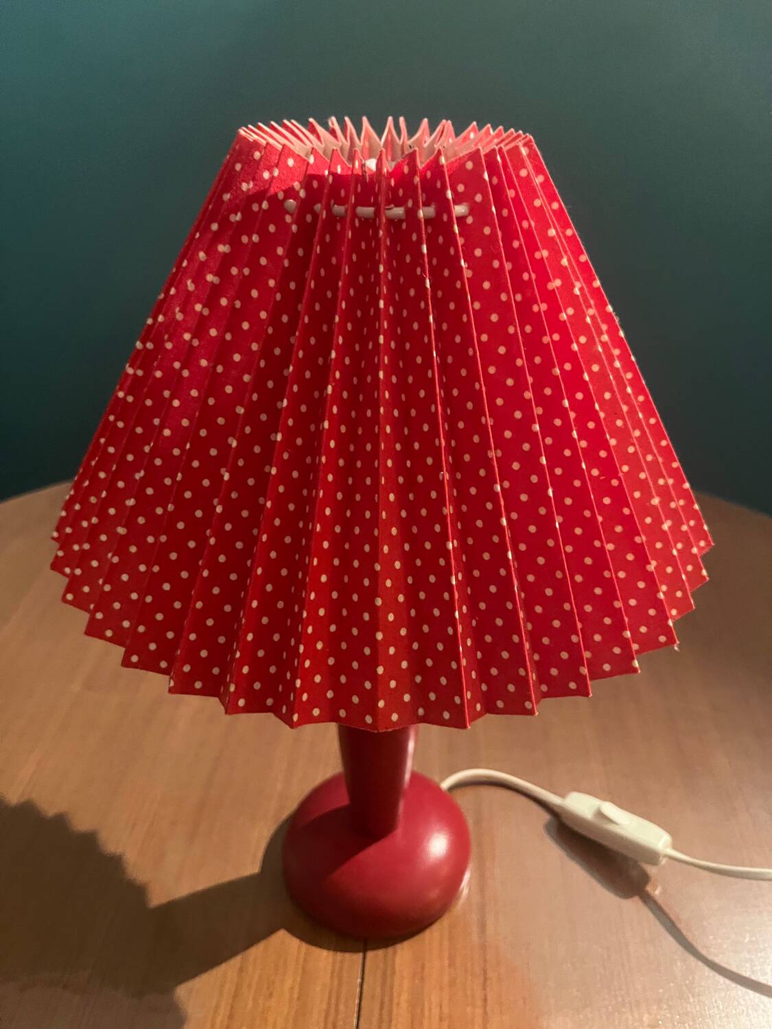 Wooden foot lamp with folded cardboard lampshade