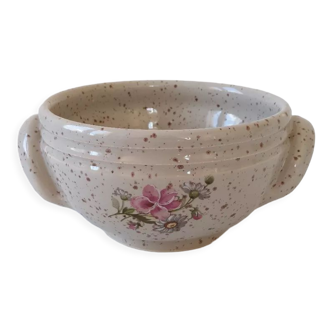 Vallauris ceramic bowl with pink and green floral decoration on a gray/brown speckled beige background