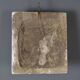 Old plaster tile with a fierce mask decoration, Italy, 19th century.