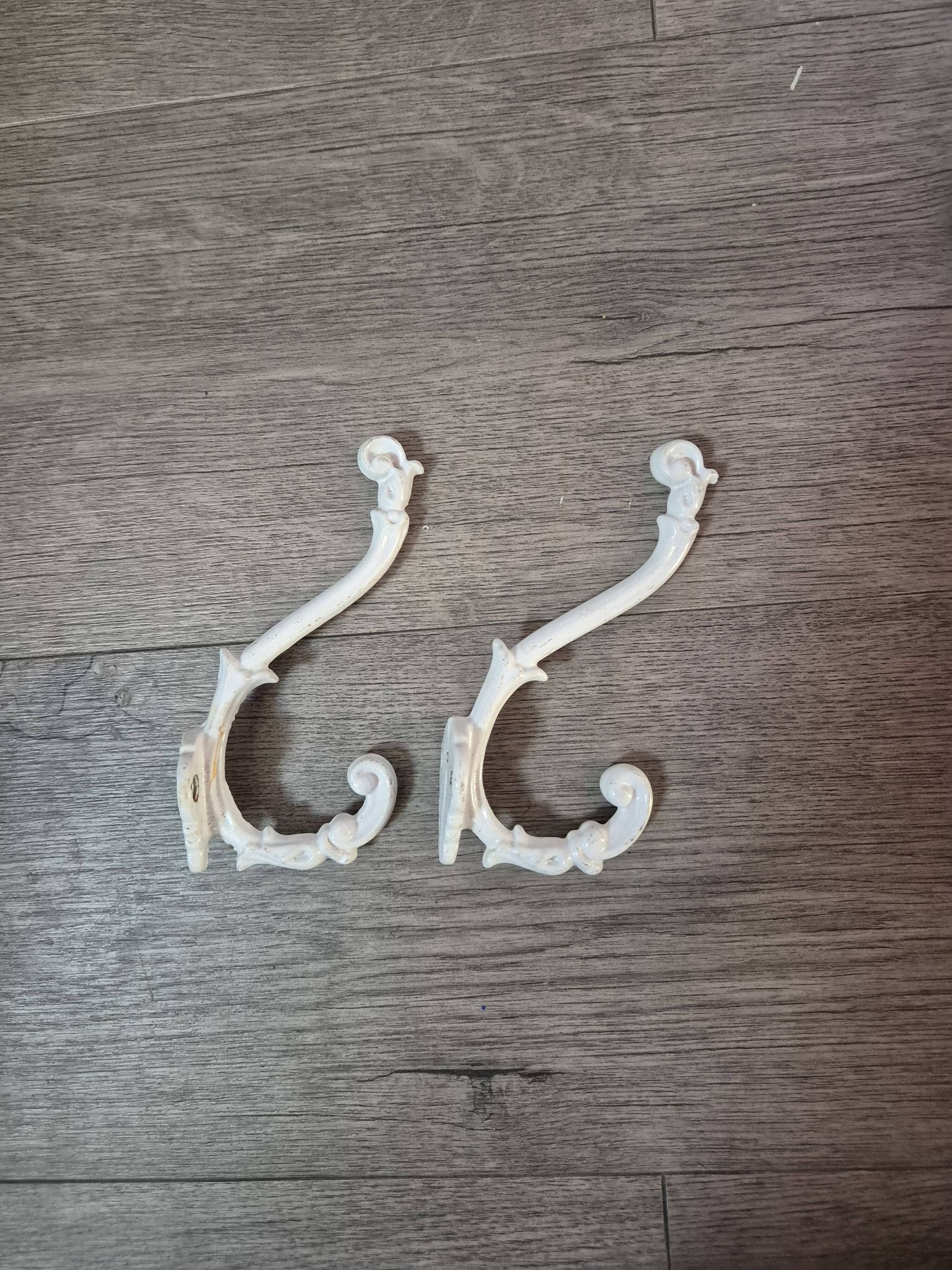 set of 2 vintage white cast iron hooks, small paint chips from the year