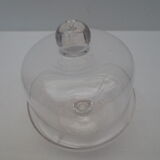 Old bell with cakes on glass stand
