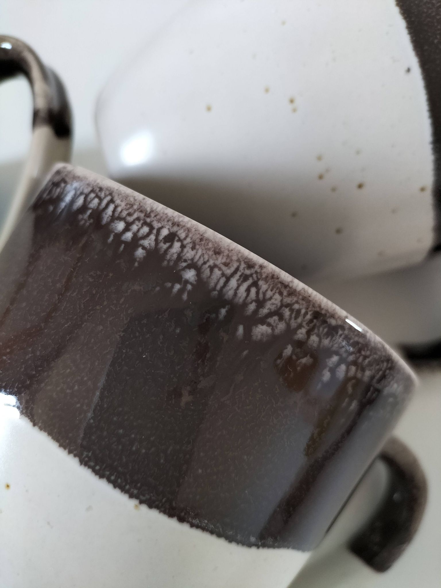 Set of three two-tone mugs, glazed stoneware, café workshop style.