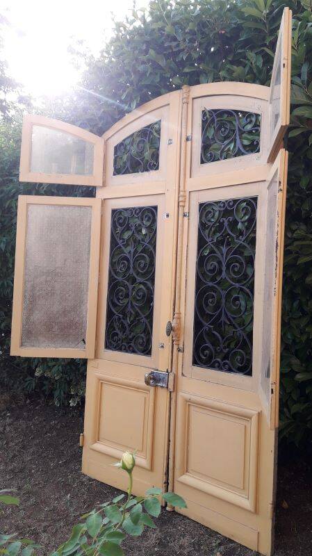 19th century double arched entrance door in oak with grilles and old glass