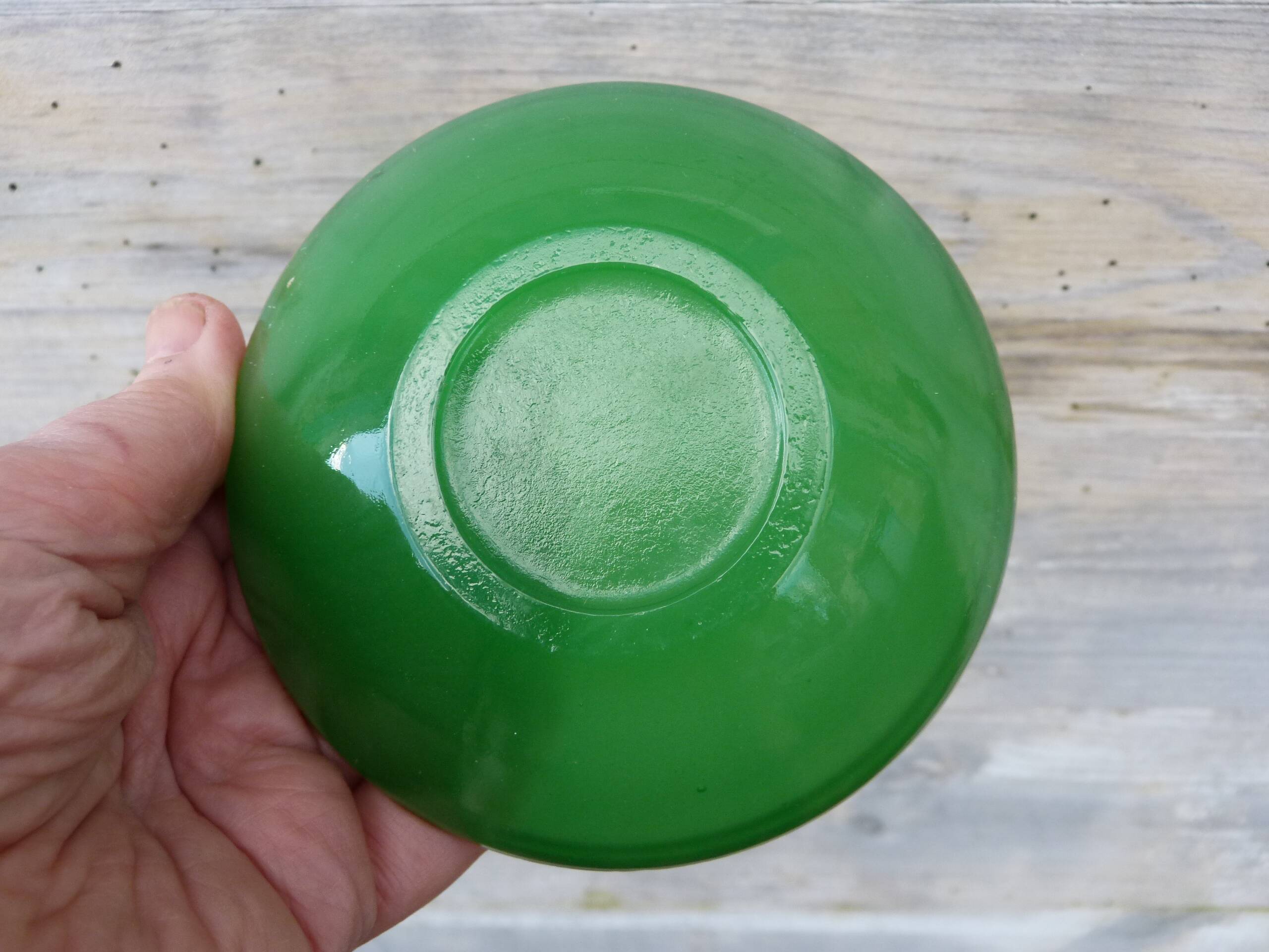 Green glass ashtray set in gold brass