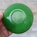 Green glass ashtray set in gold brass