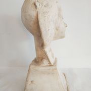 Bust of woman in plaster on pedestal with inscription