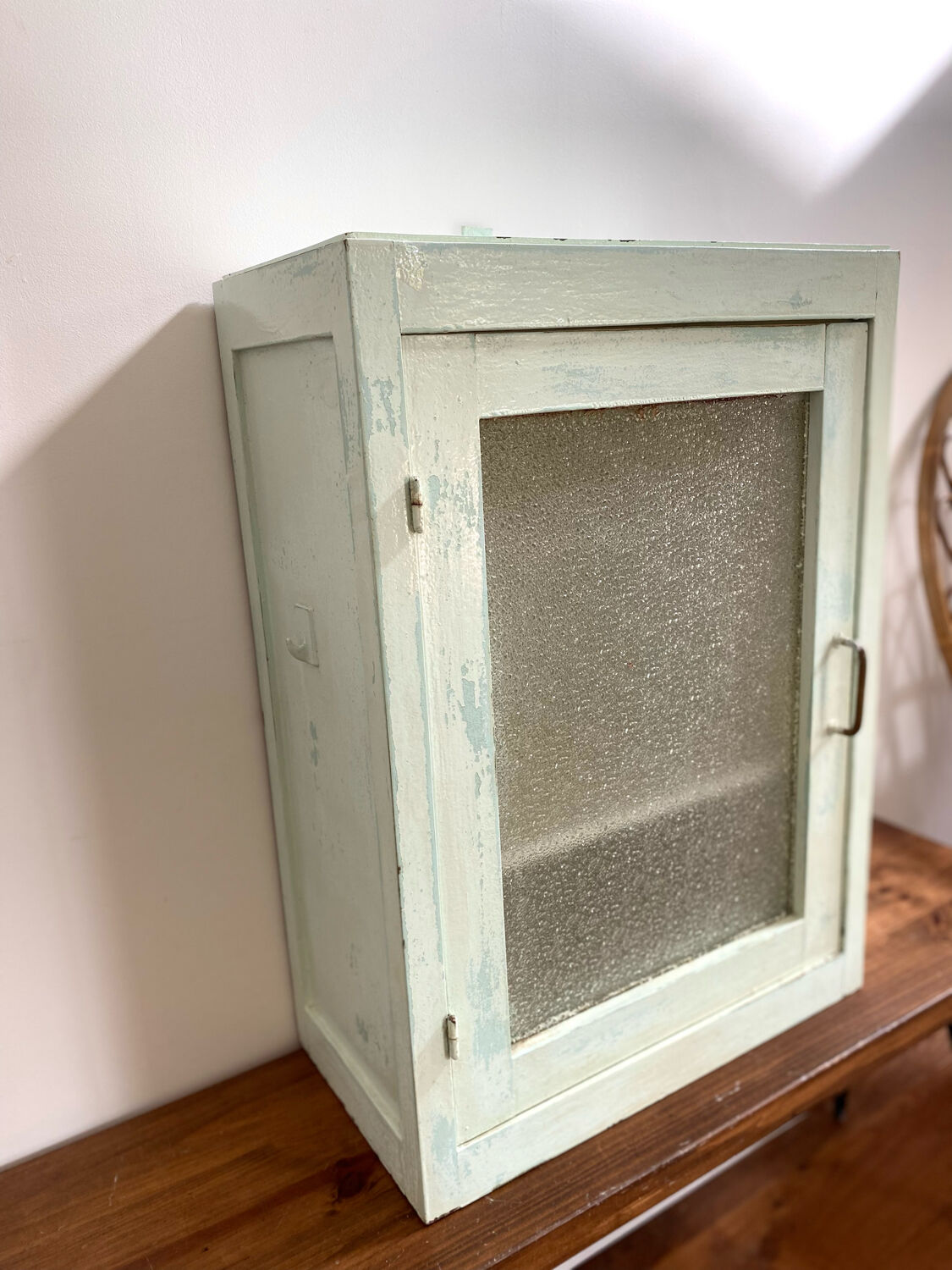 Old medicine cabinet in mint green patinated wood