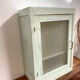 Old medicine cabinet in mint green patinated wood