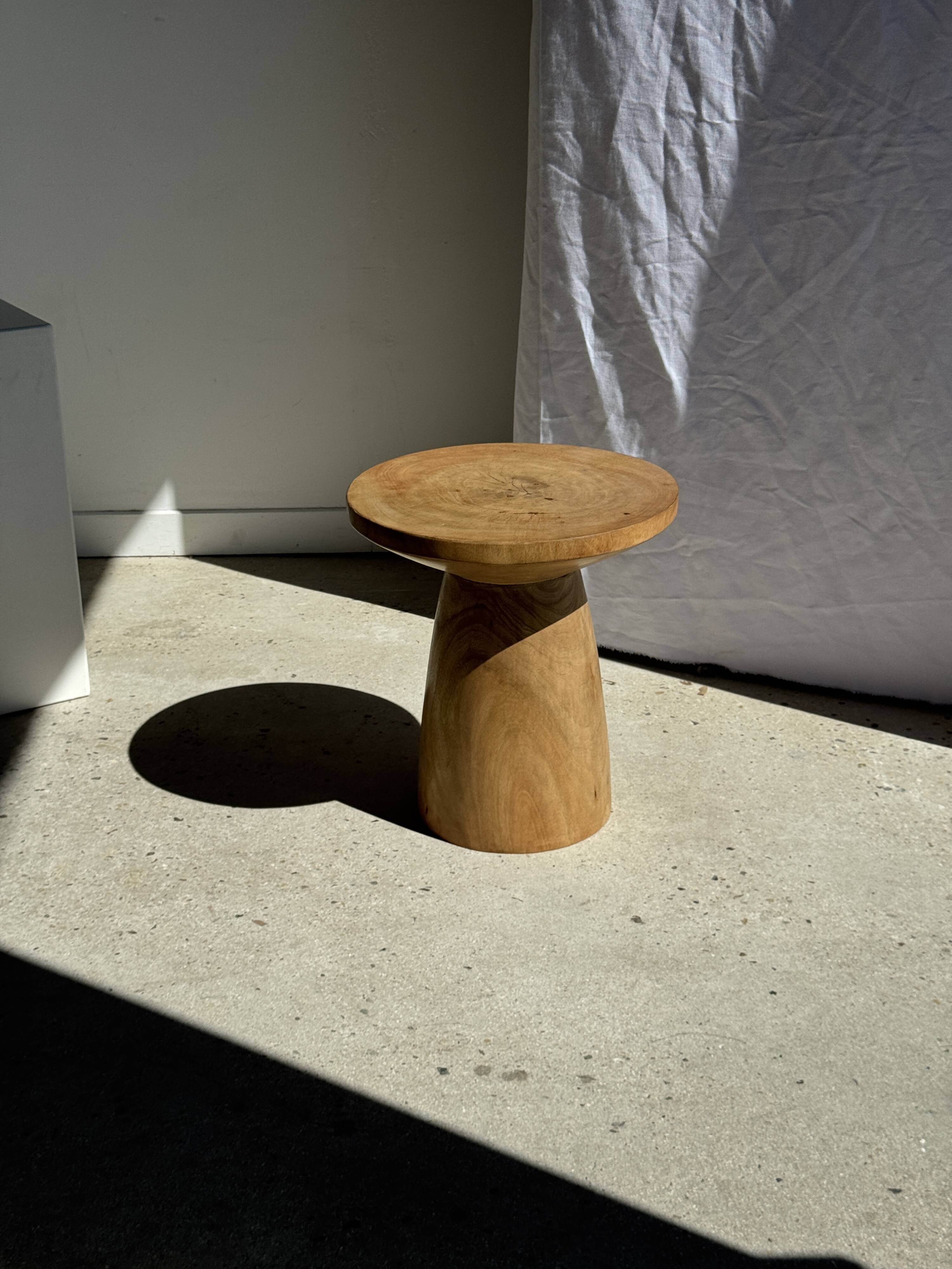 Natural solid mango side table (monoxyle) with conical legs.