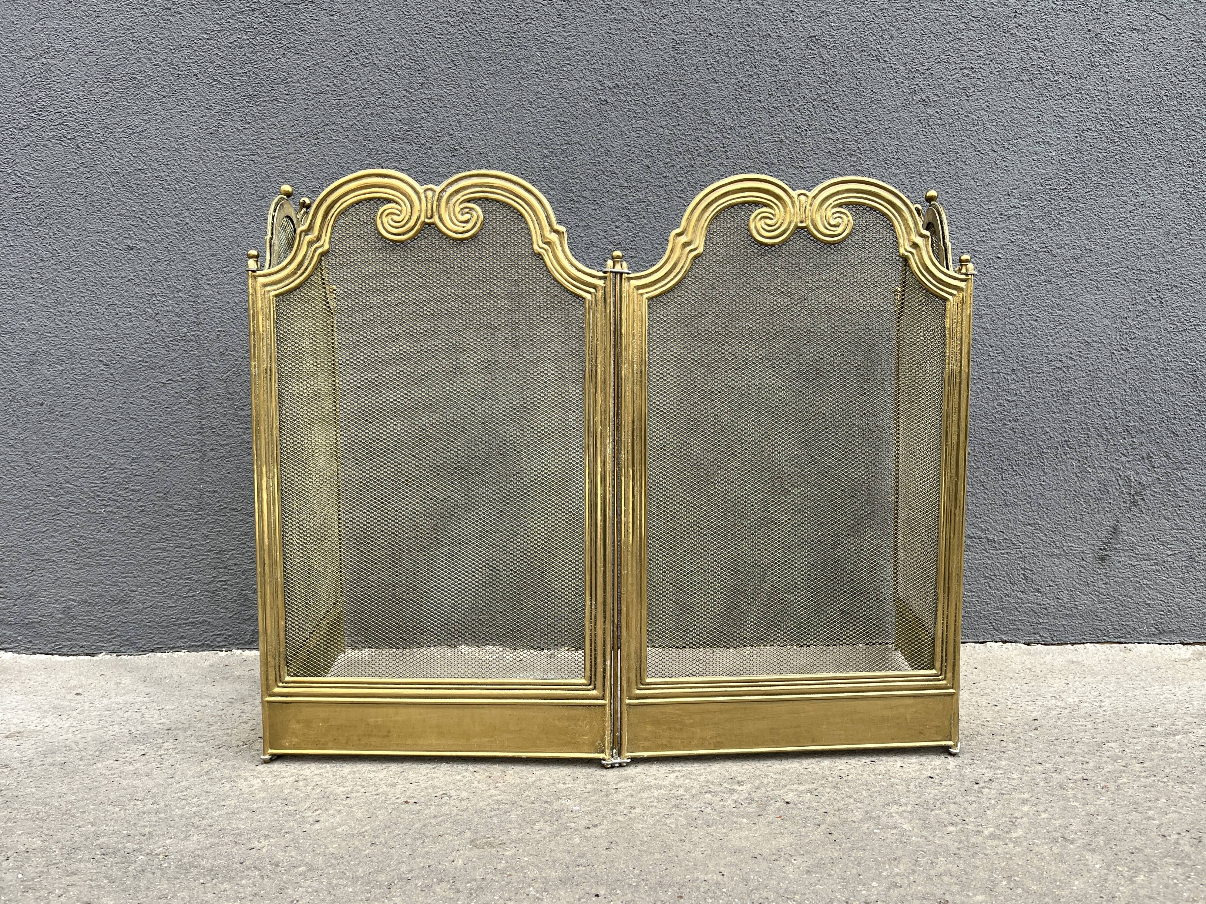 Antique brass fireplace screen from 1920, vintage spark guard.