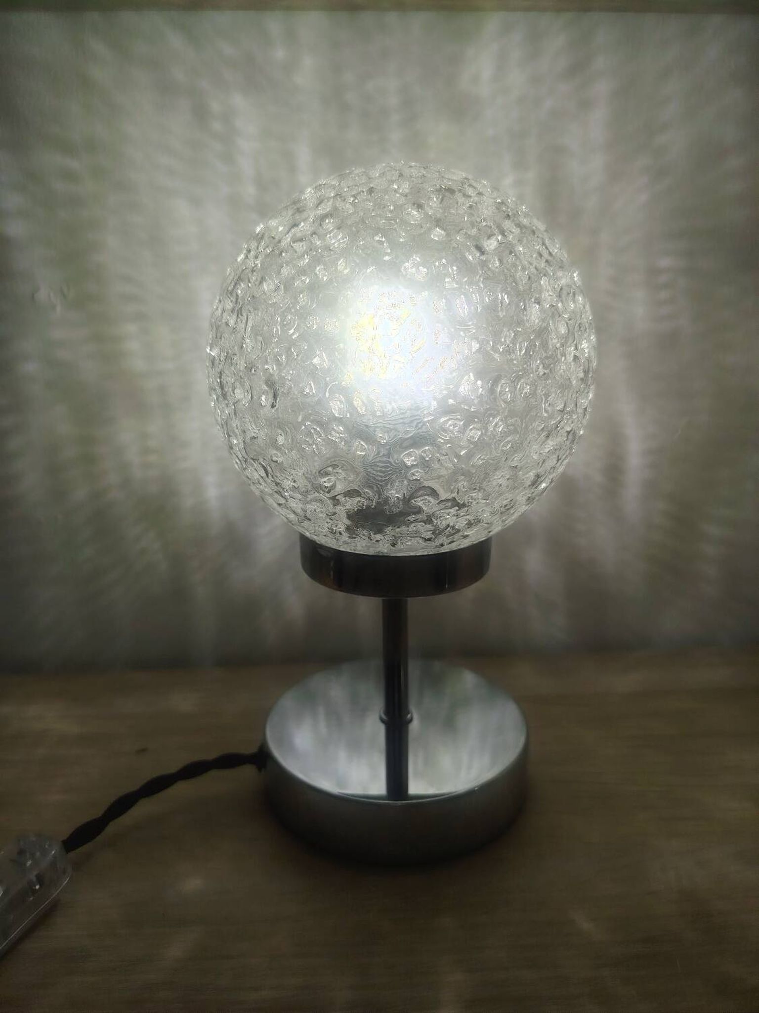 Duo of textured globe lamps with a large play of light.