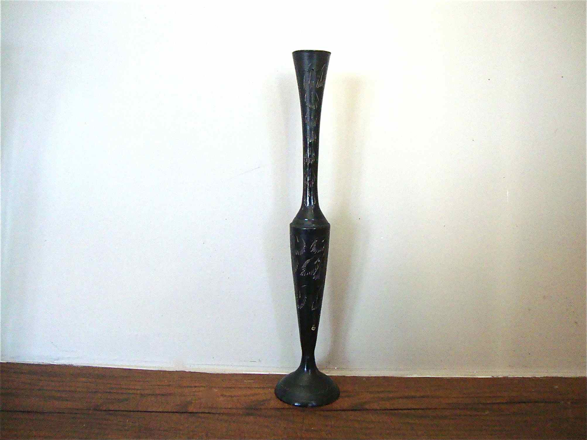 Stylized vase in engraved metal