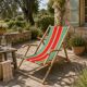 Vintage deck chair with striped green and red fabric, original patina.